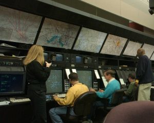 Controladores aéreos frente a pantallas de radar en un centro de control de tránsito aéreo